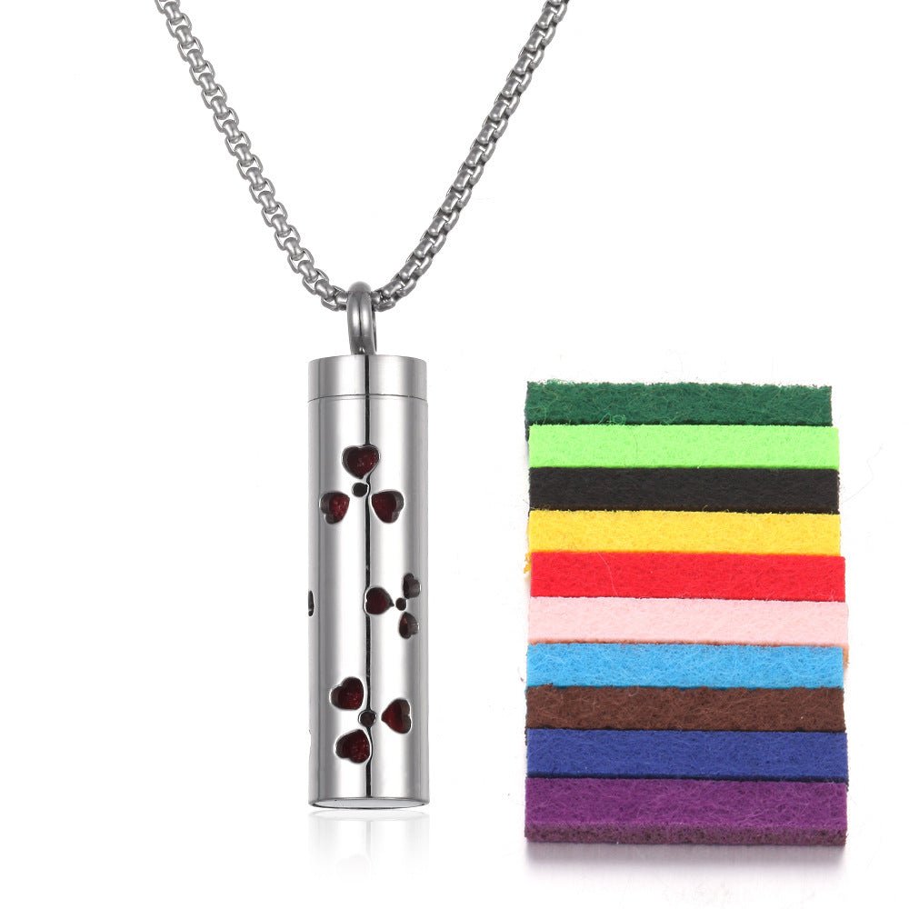 Detail close-up of the stainless steel pendant with a bottle design in silver and red.