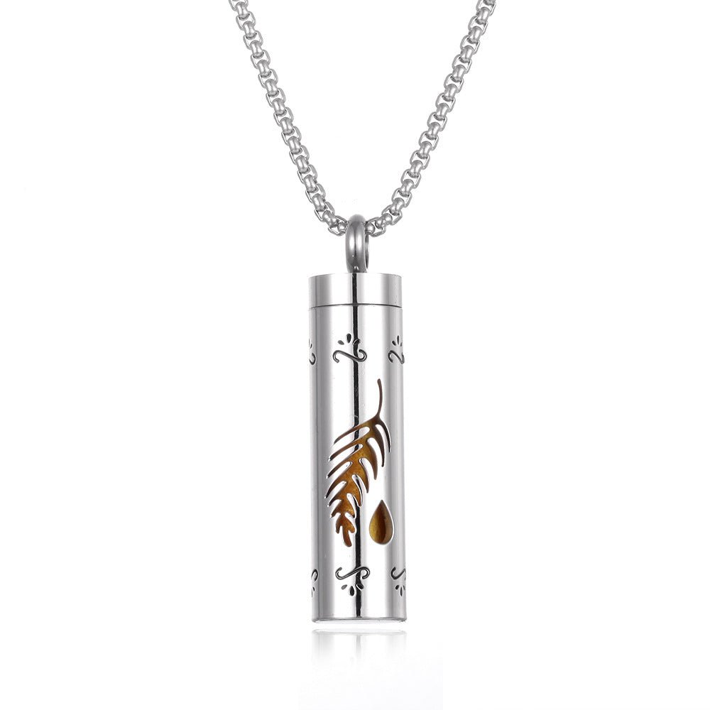 Stainless steel aromatherapy pendant in silver and brown with a long chain.
