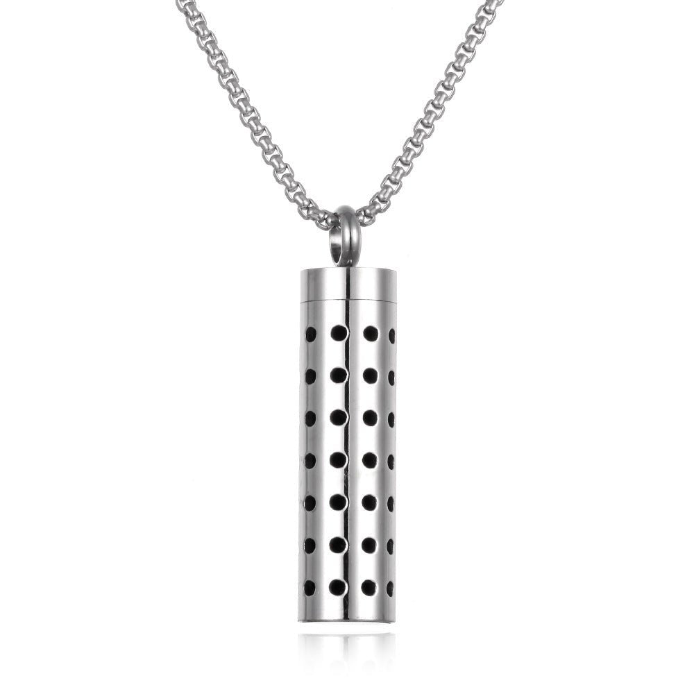 Stainless steel aromatherapy pendant in silver and black with a long chain.