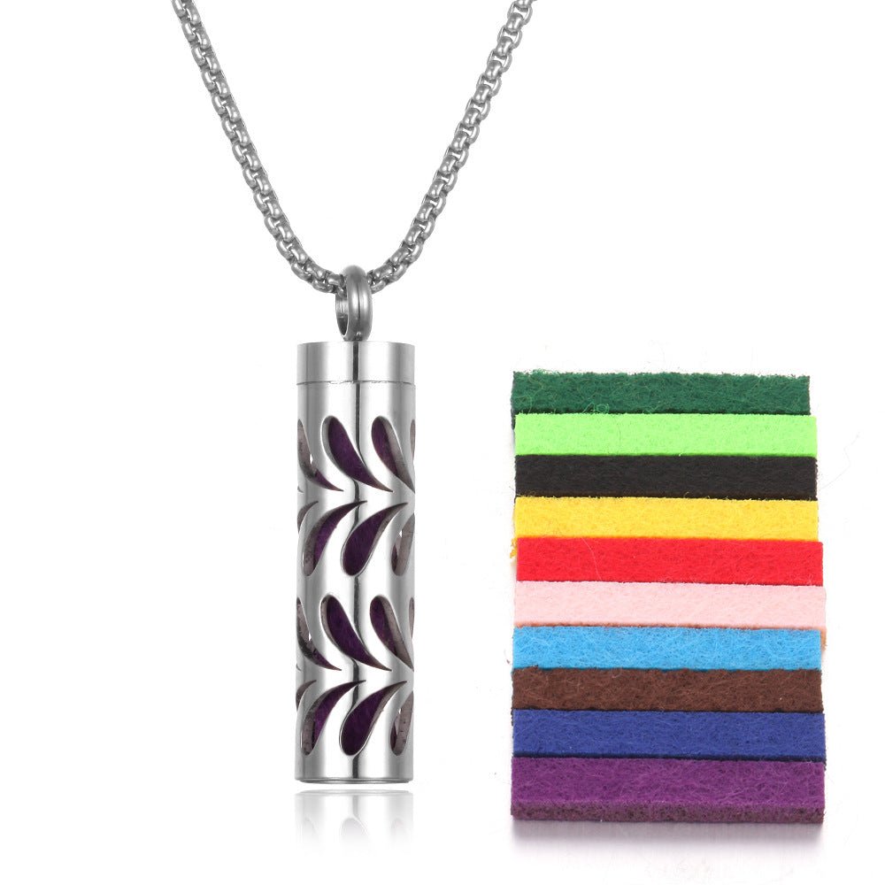 Detail close-up of the stainless steel pendant with colorful pads in green, red, and black.