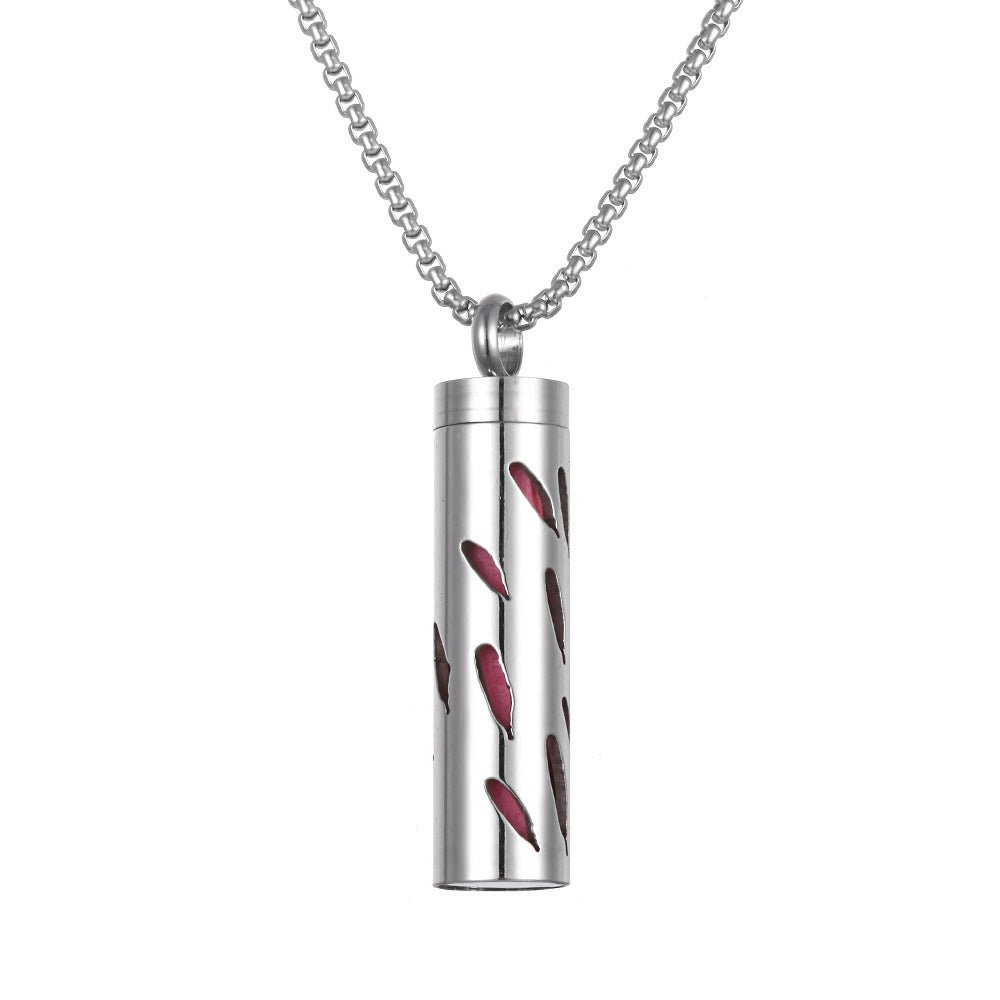 Detail close-up of the stainless steel pendant with a red accent.