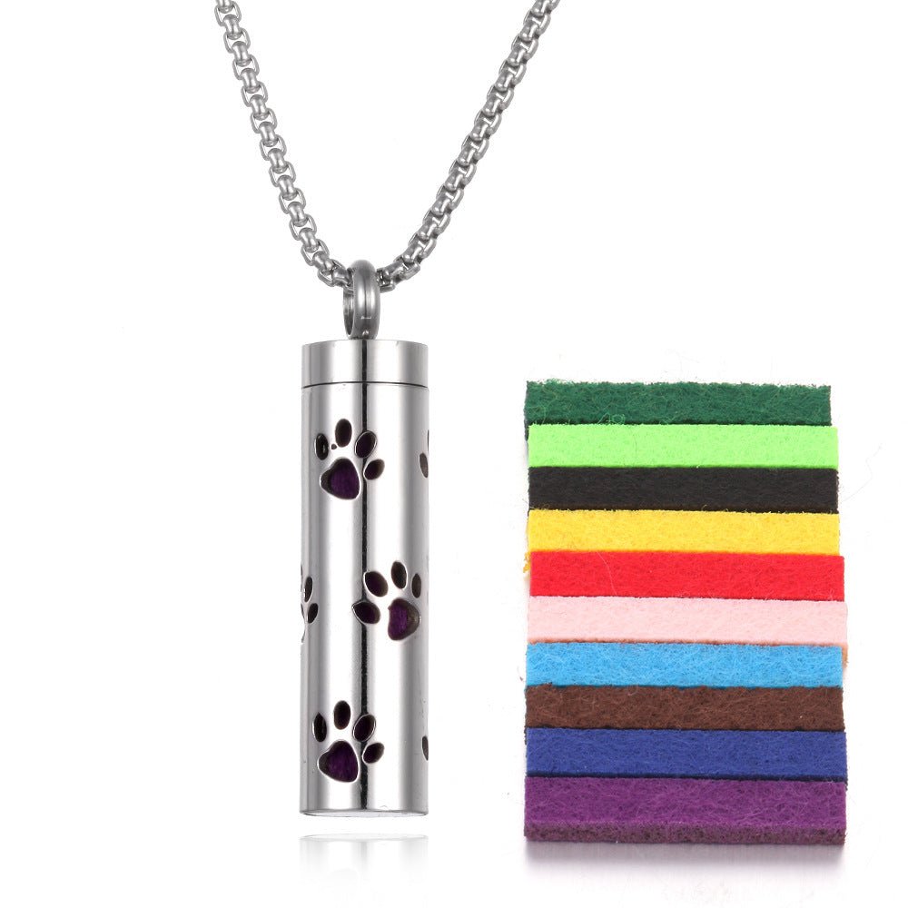 Detail close-up of the stainless steel pendant with a leaf design and colorful pads in silver and multicolor.
