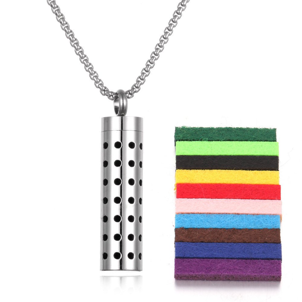 Lifestyle shot of the stainless steel aromatherapy pendant in silver with colorful pads.