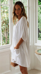 Side view of the white beach blouse showcasing its button front and loose fit, ideal for a capsule wardrobe.