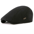 Side view of the black wool beret hat featuring a retro style, showcasing its knitted texture against a white background.