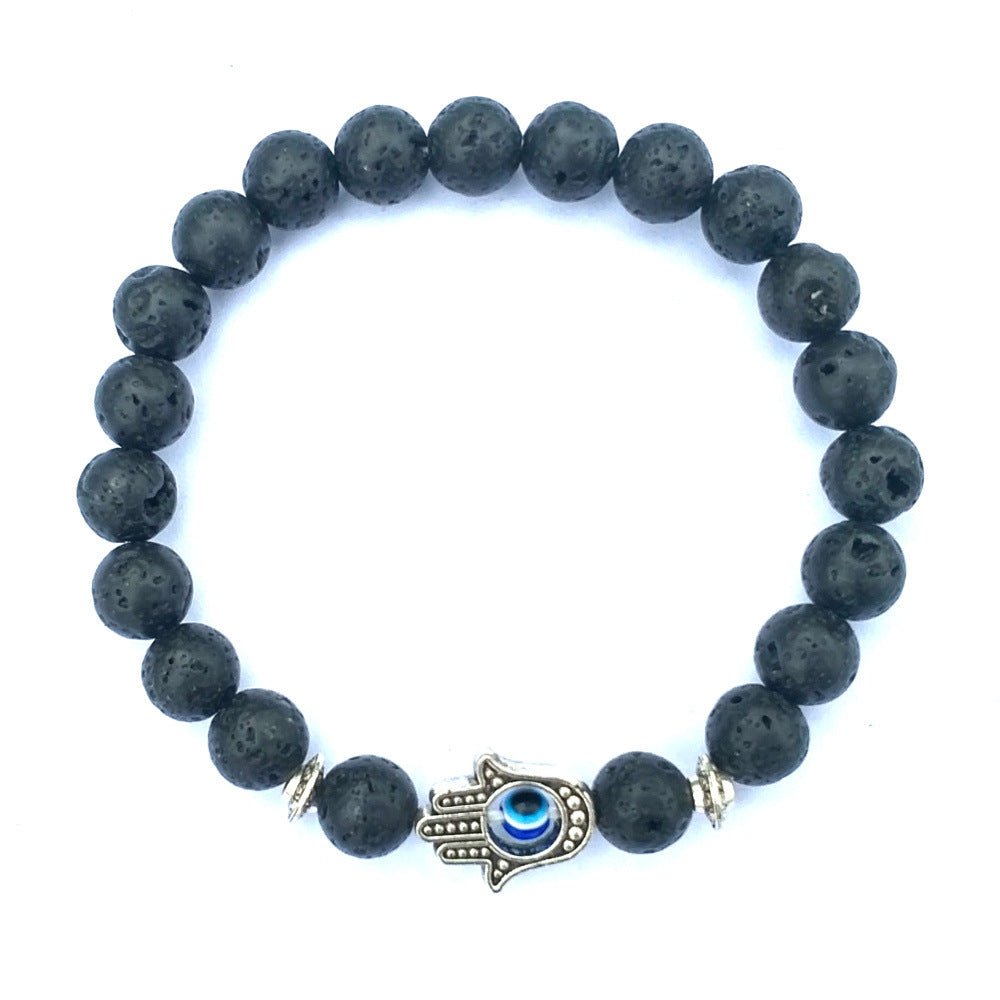 Close-up of the black stone bracelet featuring the evil eye charm and stylish beaded details.