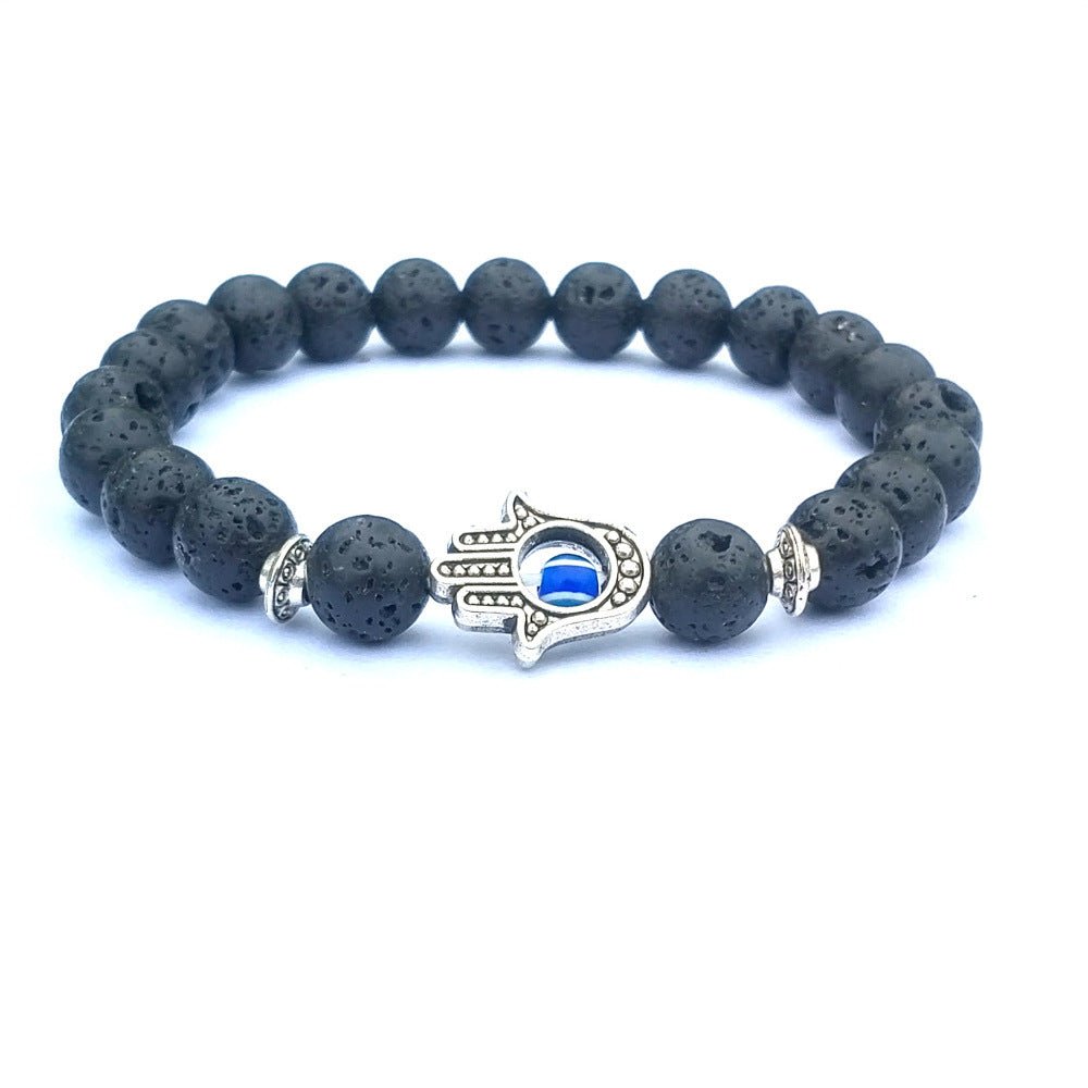 Close-up of the white stone bracelet showcasing the evil eye charm with silver accents.