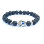 Close-up of the white stone bracelet showcasing the evil eye charm with silver accents.