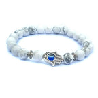 Close-up of the black and white stone bracelet highlighting the evil eye charm and intricate beading.