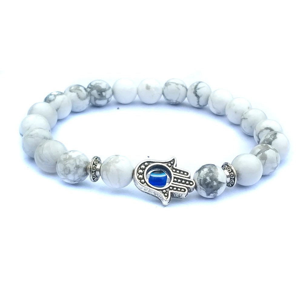 Close-up of the black and white stone bracelet highlighting the evil eye charm and intricate beading.