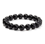 Detail of geometric black onyx bracelet with smooth beads on white background