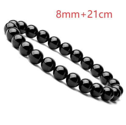 Close-up detail of black onyx bracelet with round beads and elastic band