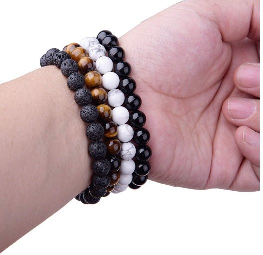 Multiple strands of black onyx bracelets with geometric design on white background