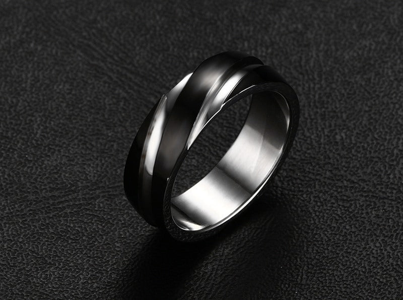 Detail view of the black titanium steel ring featuring a polished surface against a black background.