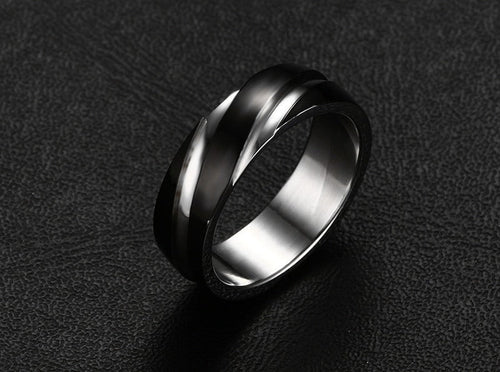 Detail view of the black titanium steel ring featuring a polished surface against a black background.