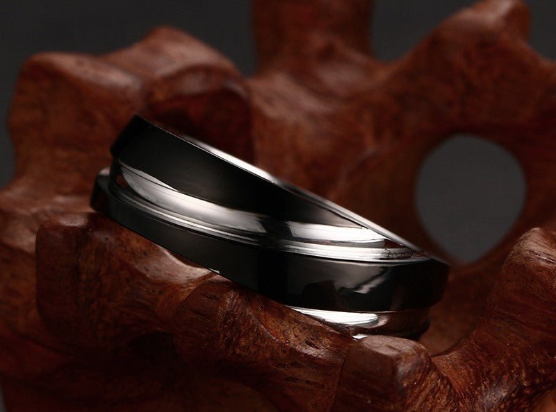 Detail close-up of the black titanium steel ring with a smooth finish on a neutral background.