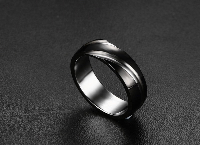 Side view of the black titanium steel ring with a smooth finish on a solid color background.