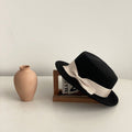 Khaki bow flat-brimmed cap against a natural background, emphasizing its stylish design and flat brim.
