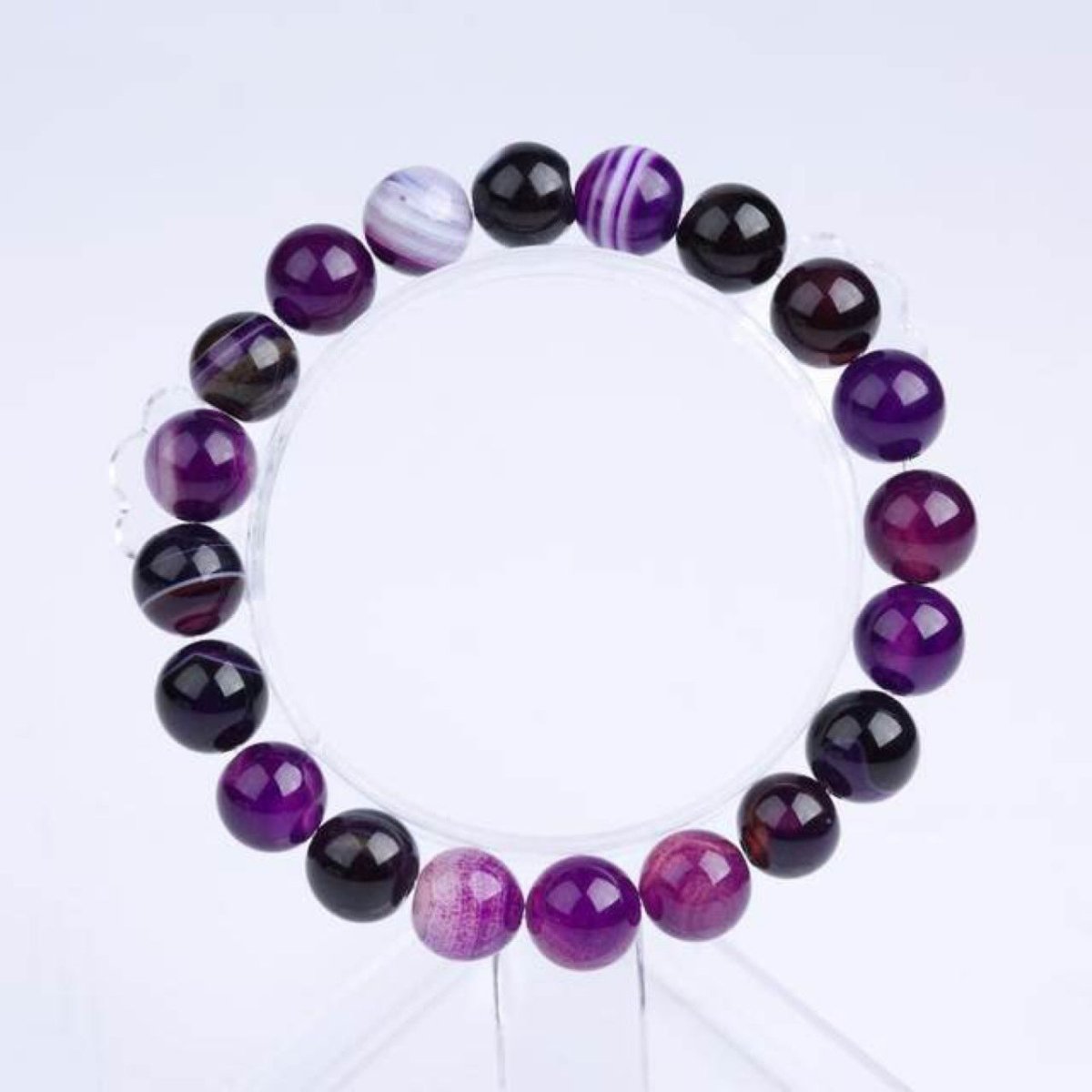 Detail shot of Violet Agate Bracelet with round beads, emphasizing its purple and black colors on a white background.