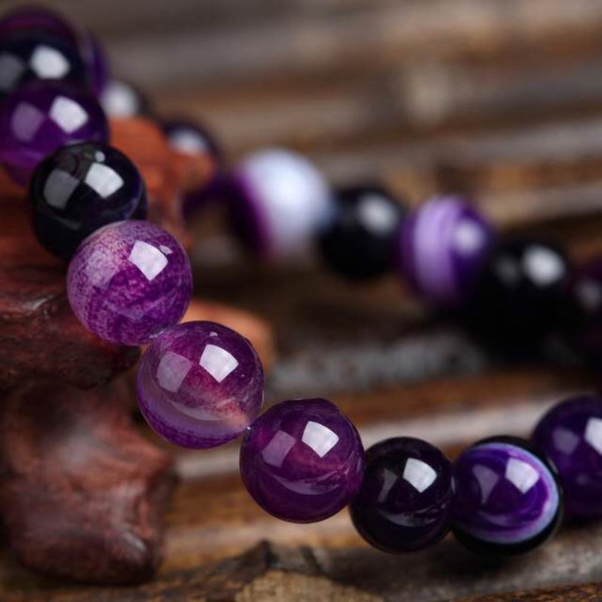 Close-up detail shot of Violet Agate Bracelet with smooth beads, highlighting its elegant design and colors.