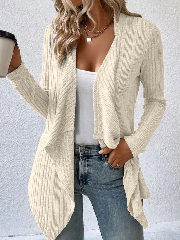 Lifestyle shot of a black cardigan sweater with long sleeves and an open front, casual chic style.