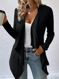 Lifestyle shot of a black cardigan sweater featuring long sleeves and an open front, stylish and versatile.