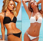 Black and white bikini in a beach setting, highlighting minimalist style and chic design