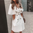 Lifestyle view of a white dress featuring double-breasted design, perfect for minimalist fashion.
