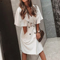 Lifestyle shot of a white dress with double-breasted features, styled for chic casual wear.