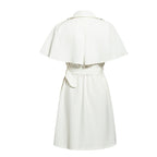 Back view of a white dress with cape sleeves and belted waist, highlighting sophisticated design.