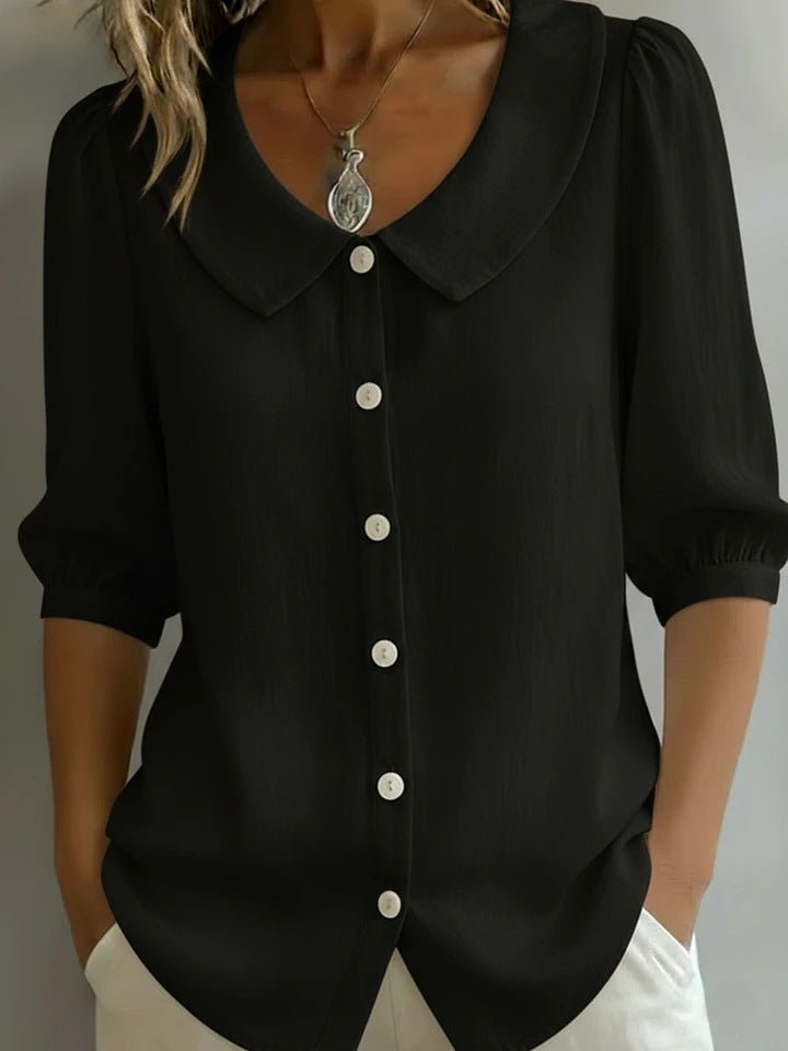 Front view of the black collared blouse featuring buttons and short sleeves, elegant casual look.