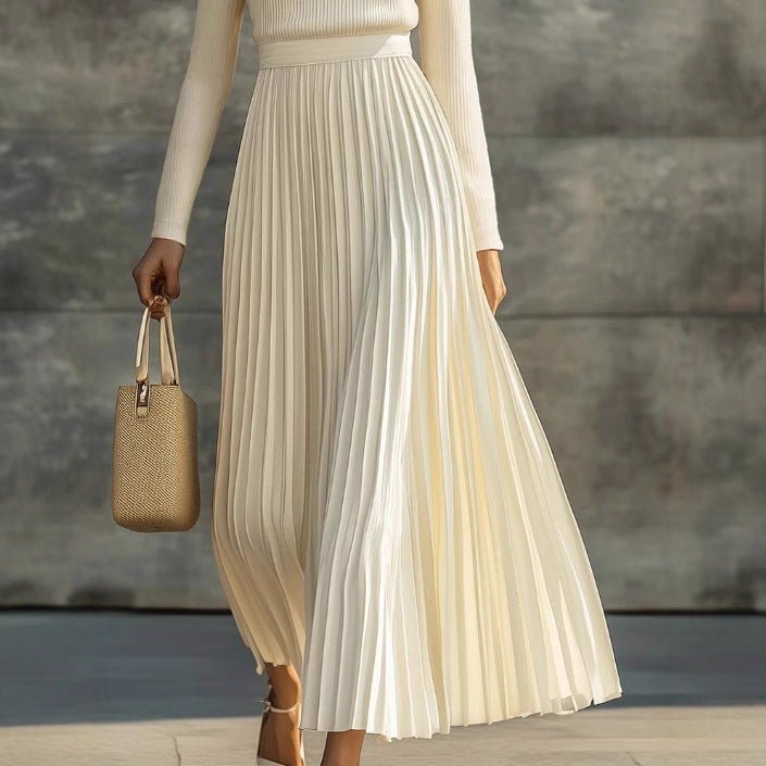 Detail of a cream pleated satin maxi dress with handbag, showcasing elegant minimalist fashion @Black#White