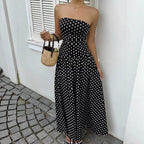 Chic black off-shoulder dress with strapless design and flowy skirt in lifestyle shot.