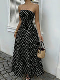 Stylish black off-shoulder dress featuring a strapless design and flowy skirt in lifestyle shot.