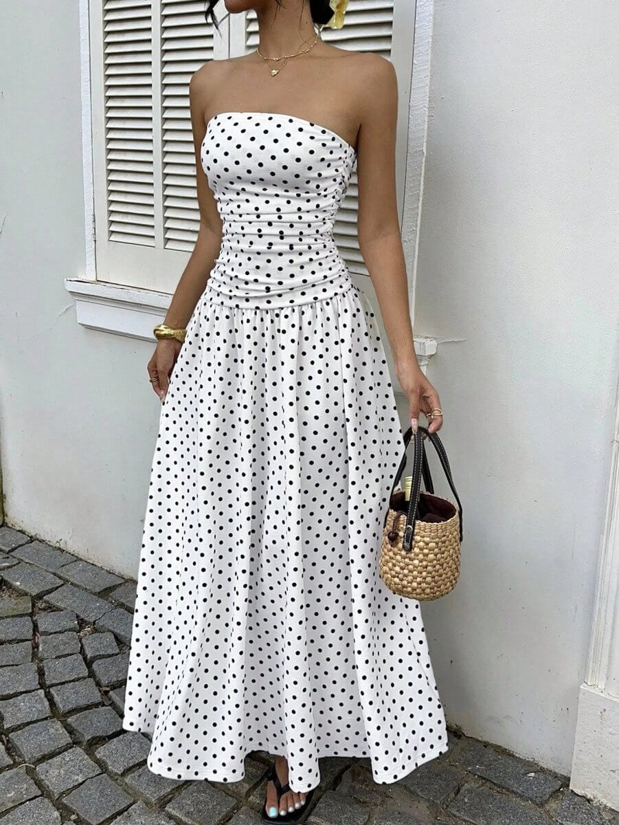 Elegant white off-shoulder dress with strapless design and flowy skirt in lifestyle shot.