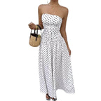 Sophisticated white off-shoulder dress with strapless design and flowy skirt in lifestyle shot.