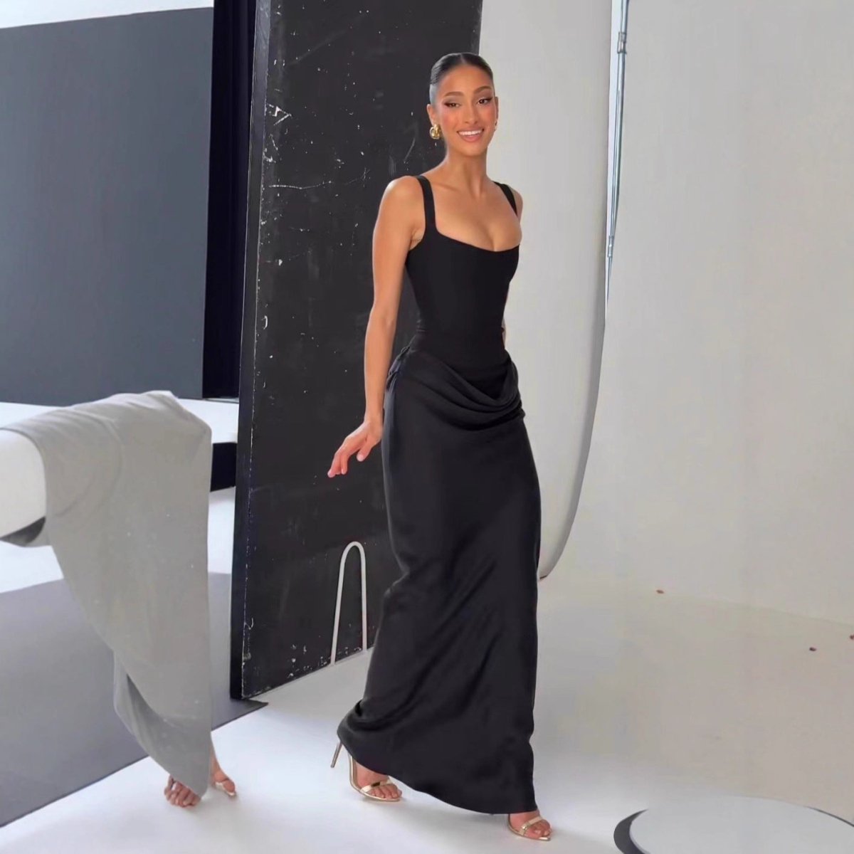 Chic black strapless long slip dress, elegant minimalist design in lifestyle shot