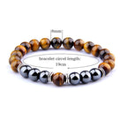 Detail close-up highlighting the yellow tiger eye bracelet's beaded design and elastic band.
