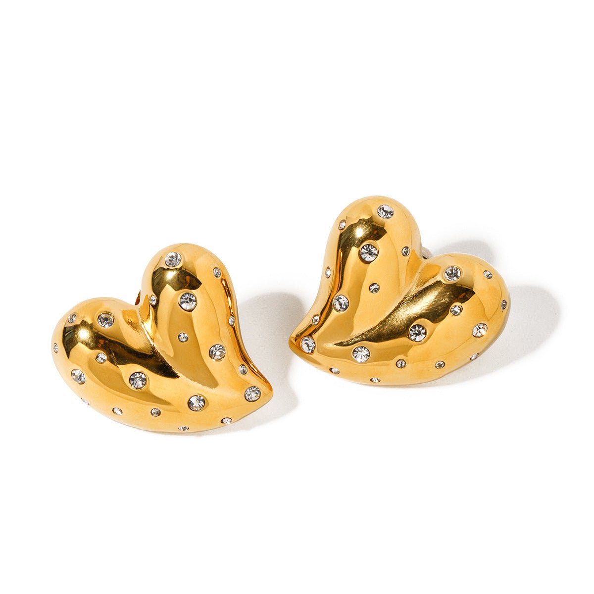 Lightweight gold heart earrings, detail close-up highlighting the shiny surface.