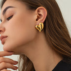 Lifestyle shot of a woman wearing gold heart earrings, showcasing the elegant heart shape.
