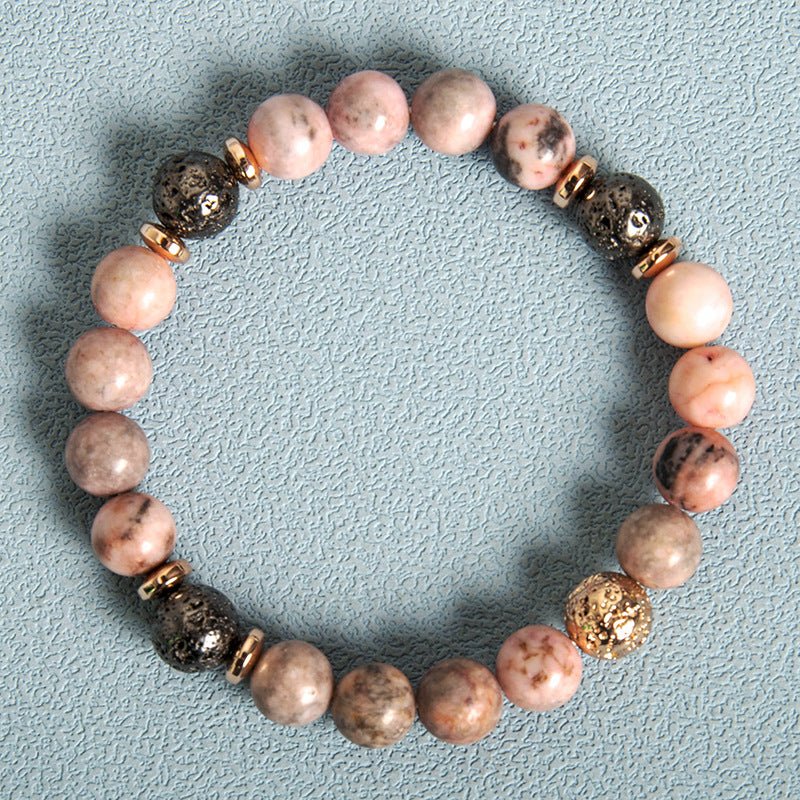 Detail close-up of pink zebra stone bracelet showcasing beaded design and natural stones.