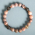 Detail close-up of pink zebra stone bracelet showcasing beaded design and natural stones.
