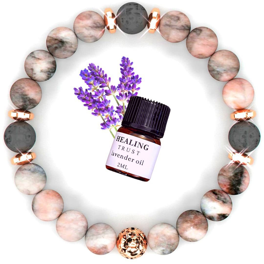 Lifestyle shot of pink zebra stone bracelet surrounded by lavender flowers, highlighting chic fashion.