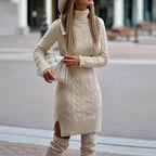 Beige knitted turtleneck dress with side slits, elegant minimalist style in a lifestyle setting.