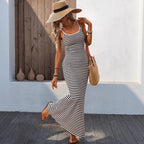 Lifestyle image of a cream knitted slip dress, highlighting the elegant spaghetti strap and maxi silhouette.