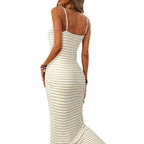 Lifestyle shot of a gray and white striped knitted slip dress, featuring spaghetti straps and a chic maxi style.