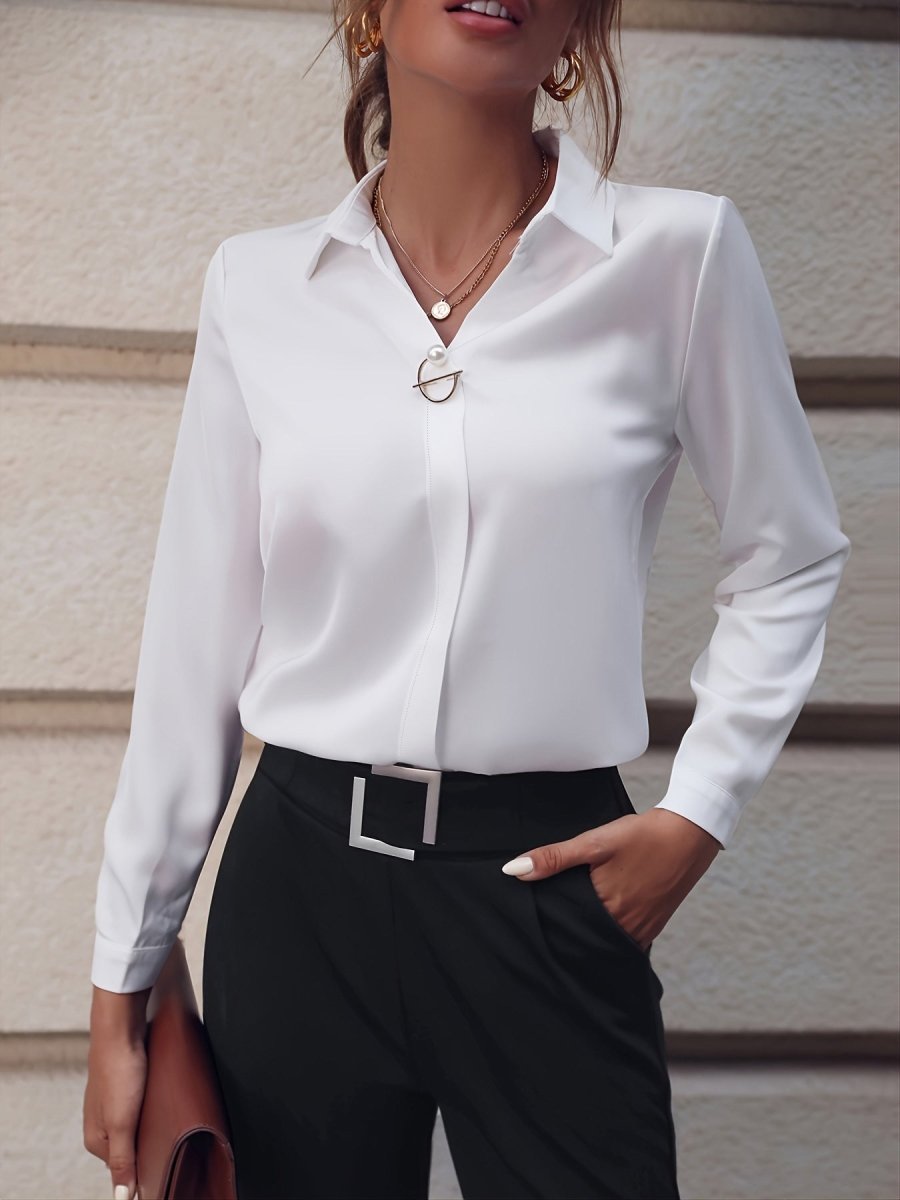 White long sleeve business shirt with pearl buttons, elegant style in a natural setting.