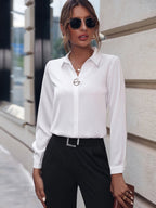 Chic white long sleeve shirt featuring pearl buttons, styled in a natural environment.