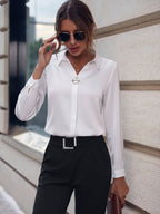 Lifestyle shot of a white long sleeve business shirt with pearl buttons in a natural setting.