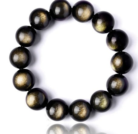 Detail shot of Gold Sapphire Bracelet with round beads, showcasing black and gold colors on a white background.